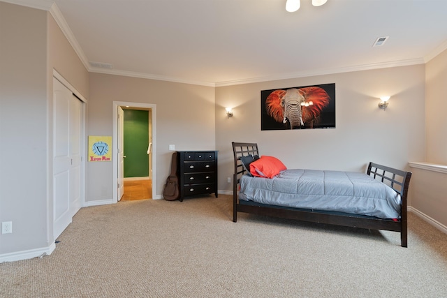 carpeted bedroom featuring baseboards, visible vents, and ornamental molding