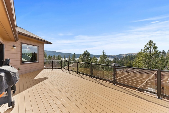 deck featuring a mountain view and a grill