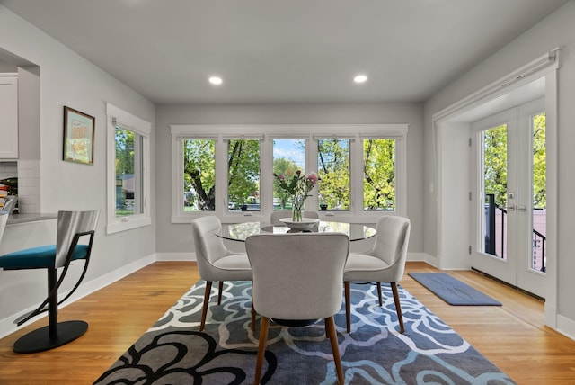 dining area with recessed lighting, baseboards, french doors, and light wood-style floors