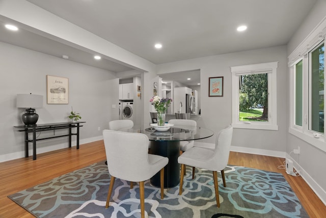 dining space with washer / clothes dryer, recessed lighting, baseboards, and wood finished floors
