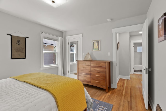 bedroom featuring baseboards and light wood-style flooring