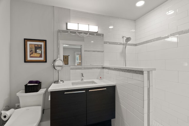 full bathroom with vanity, walk in shower, and toilet