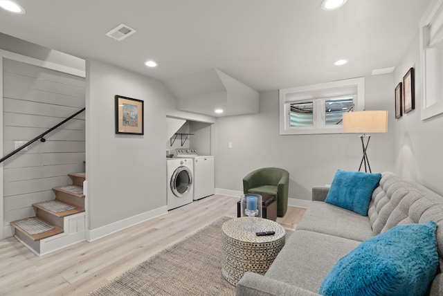 interior space featuring separate washer and dryer, visible vents, wood finished floors, and recessed lighting