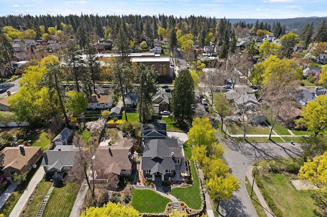 aerial view featuring a wooded view and a residential view