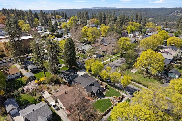drone / aerial view with a view of trees and a residential view