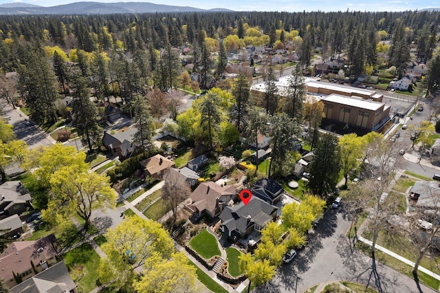 bird's eye view featuring a view of trees, a mountain view, and a residential view