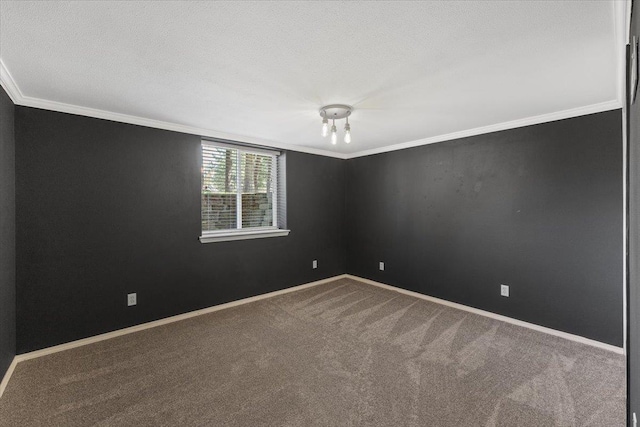 carpeted spare room with crown molding, a textured ceiling, and baseboards