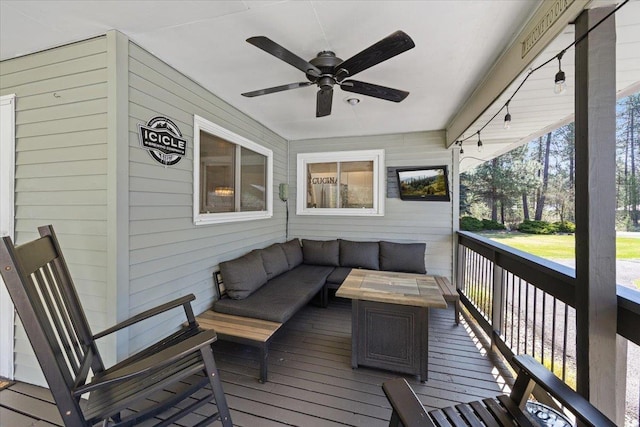wooden deck featuring an outdoor hangout area and ceiling fan