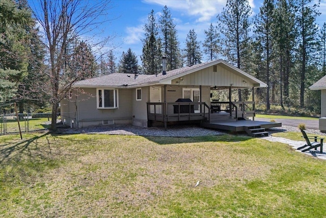 back of house with fence, ceiling fan, a yard, and a deck