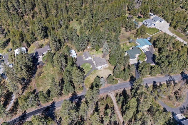 birds eye view of property with a view of trees