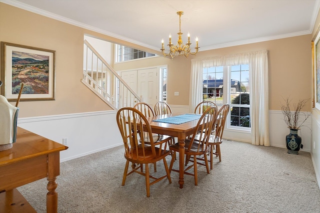 carpeted dining room featuring crown molding, plenty of natural light, and a chandelier