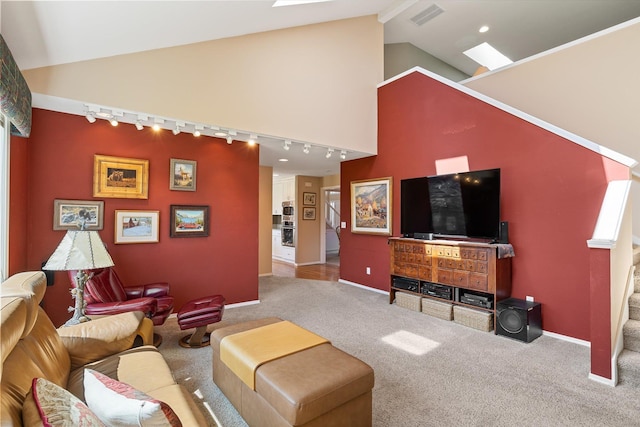carpeted living area featuring track lighting, baseboards, vaulted ceiling, and visible vents