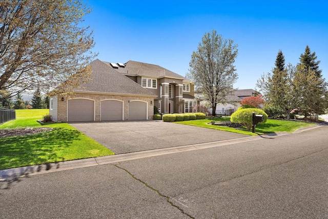 view of front of house featuring aphalt driveway, a front yard, roof with shingles, brick siding, and an attached garage