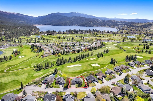 bird's eye view with a residential view, view of golf course, and a water and mountain view