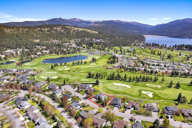 birds eye view of property with a water and mountain view, golf course view, and a residential view