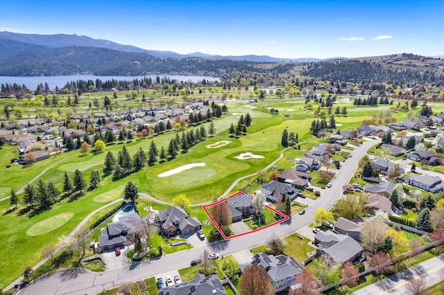 aerial view featuring a residential view, golf course view, and a water and mountain view