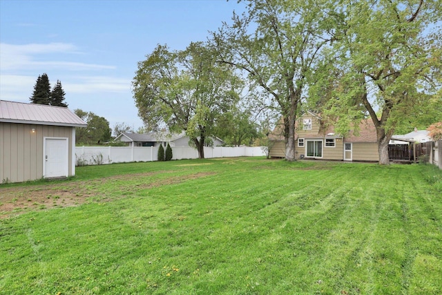 view of yard with an outbuilding and a fenced backyard