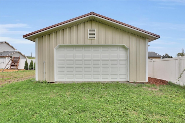 detached garage featuring fence