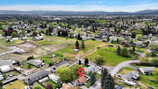 drone / aerial view featuring a residential view and a mountain view