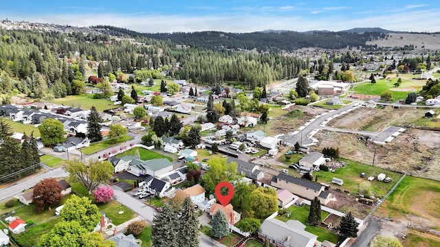 birds eye view of property with a view of trees, a mountain view, and a residential view