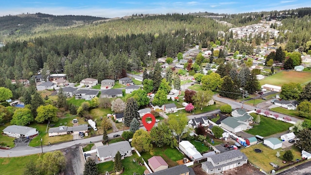 birds eye view of property featuring a residential view and a view of trees