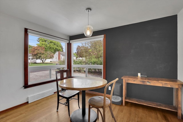 dining space featuring visible vents, baseboards, and wood finished floors