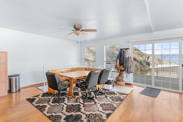 dining space featuring light wood-type flooring, baseboards, ceiling fan, and visible vents