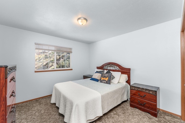 carpeted bedroom featuring baseboards