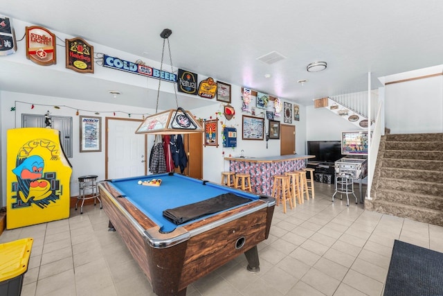 game room with tile patterned floors, visible vents, bar, and pool table