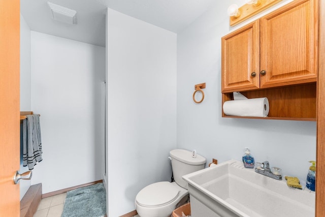 bathroom with tile patterned flooring, vanity, toilet, baseboards, and visible vents