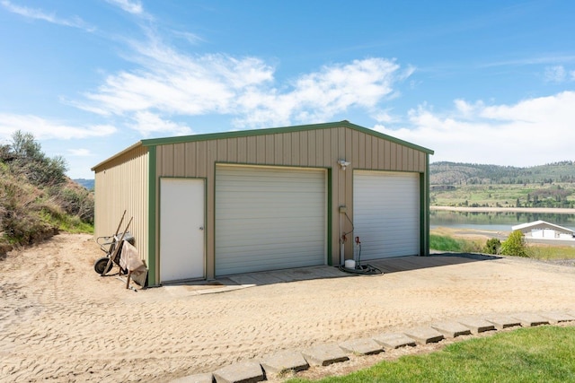 detached garage featuring a water view