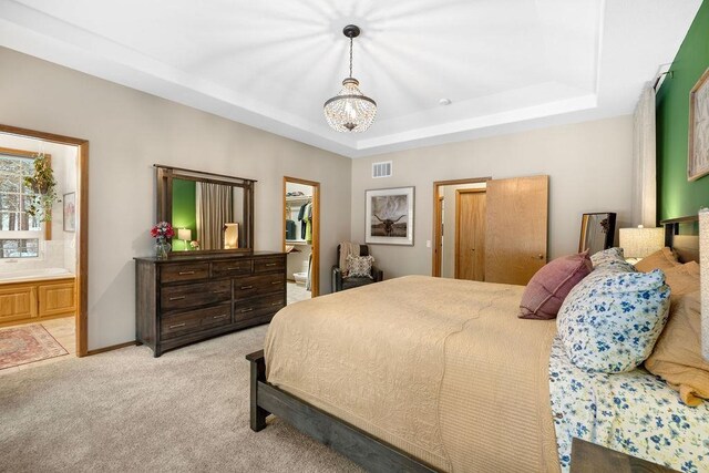 815 E Shelter Ln, Deer Park, WA 99006 - bedroom with a tray ceiling, light colored carpet, a chandelier, and connected bathroom