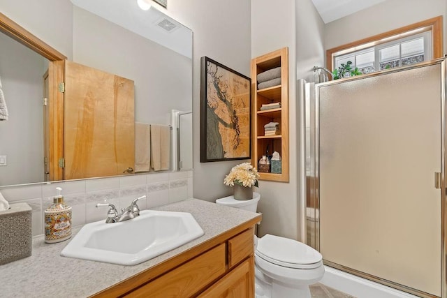 815 E Shelter Ln, Deer Park, WA 99006 - bathroom featuring a shower stall, vanity, toilet, and tasteful backsplash