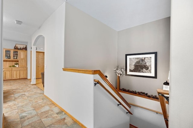 815 E Shelter Ln, Deer Park, WA 99006 - stairs with arched walkways, baseboards, and stone finish floors