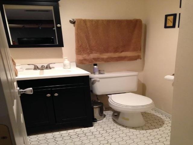bathroom with vanity, tile patterned floors, and toilet