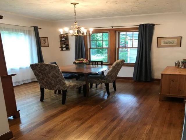 dining room featuring baseboards, dark wood-style flooring, and a notable chandelier