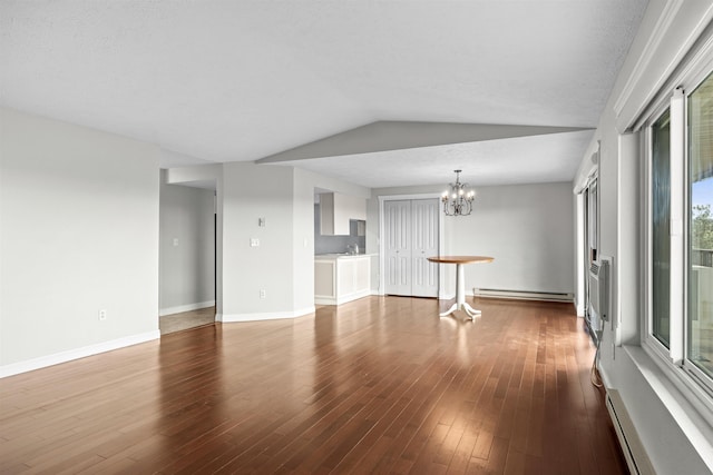 172 S Coeur Dalene St Unit G-303, Spokane, WA 99201 - unfurnished living room with a baseboard radiator, a chandelier, wood finished floors, lofted ceiling, and baseboards