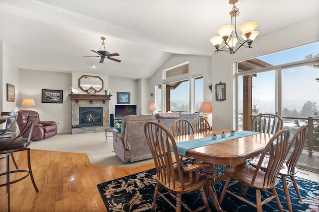 813 E Wandermere Estates Ln, Spokane, WA 99208 - dining space with plenty of natural light, a tile fireplace, a ceiling fan, a chandelier, and lofted ceiling