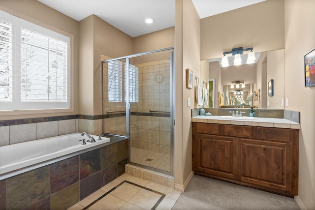 full bathroom with vanity, tile patterned flooring, a bath, and a stall shower