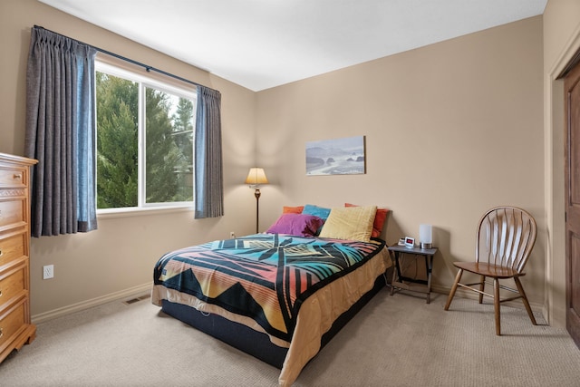bedroom with baseboards, carpet, and visible vents