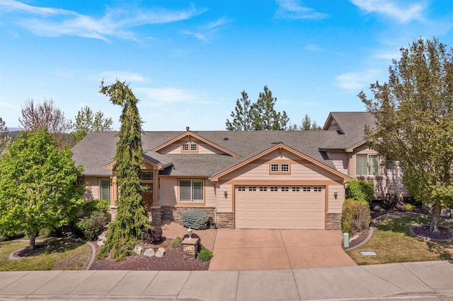 craftsman-style house featuring concrete driveway, stone siding, and a garage