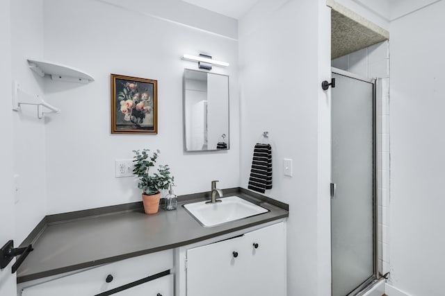 bathroom featuring vanity and a shower stall