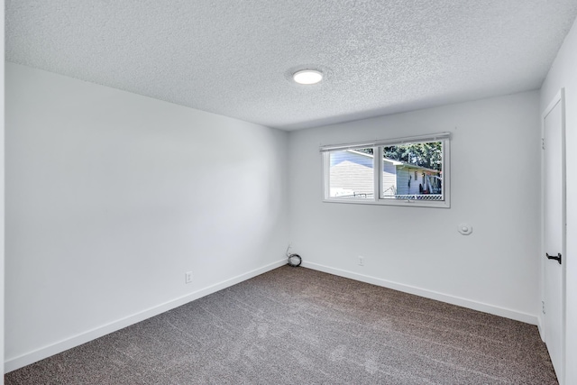 unfurnished room featuring carpet floors, a textured ceiling, and baseboards