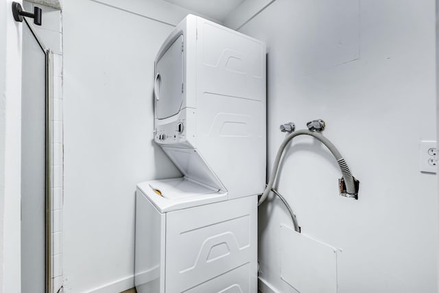 laundry area featuring laundry area and stacked washer / dryer