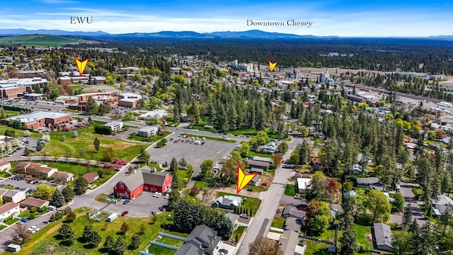 birds eye view of property with a view of trees and a mountain view