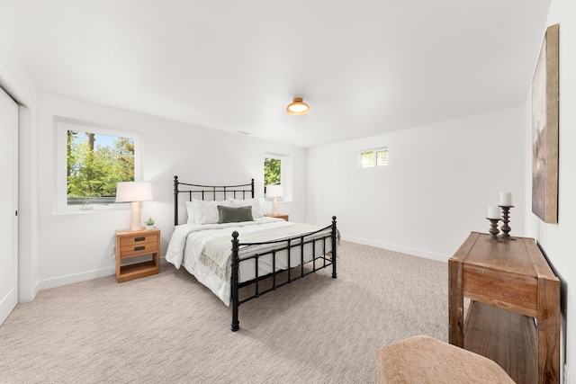 bedroom with baseboards and carpet