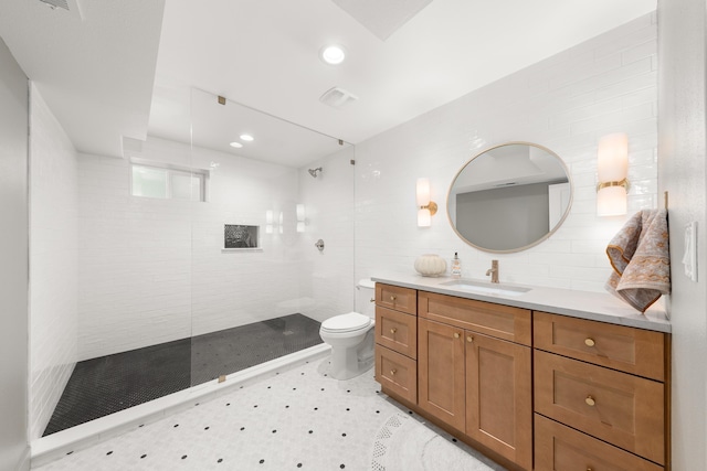 bathroom with walk in shower, vanity, toilet, recessed lighting, and tile walls