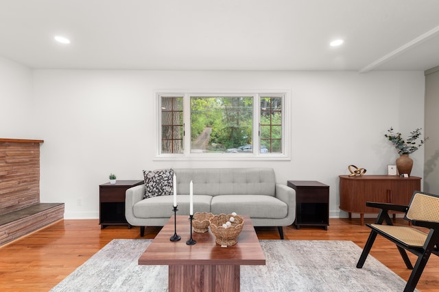 living room with recessed lighting, baseboards, and wood finished floors