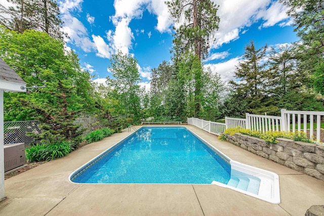 outdoor pool featuring a fenced backyard and a patio area