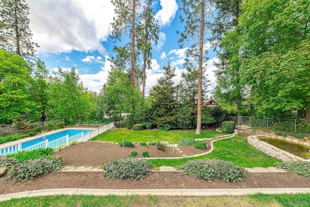 view of swimming pool featuring a fenced in pool, fence, and a yard